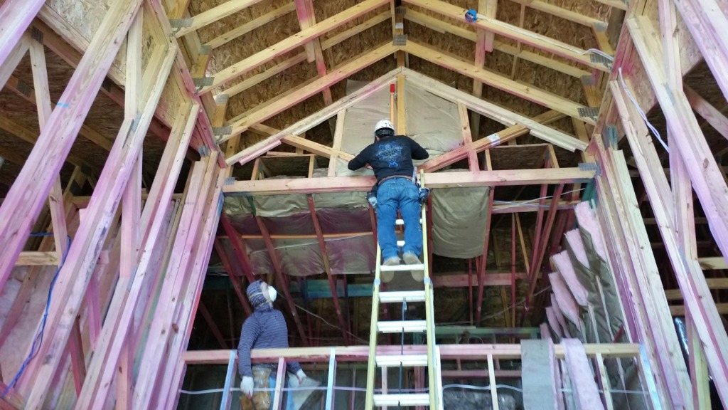 Max Insulation crew installing insulation in a large attic space